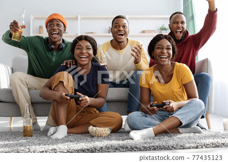 Joyful black fellows having fun at home Joyful black fellows having fun at home 77435123