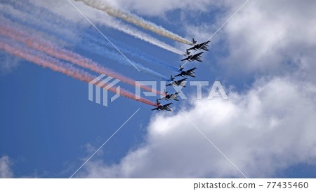 MOSCOW, RUSSIA - MAY 7, 2021: Avia parade in Moscow. Group of Russian fighters Sukhoi Su-25 with painted russian flag in the sky on parade of Victory in World War II in Moscow, Russia 77435460