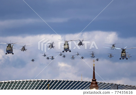 MOSCOW, RUSSIA - MAY 7, 2021: Avia parade in Moscow. Mi-26 and Mi-8AMTK helicopters fly in the sky on parade of Victory in World War II in Moscow, Russia 77435616