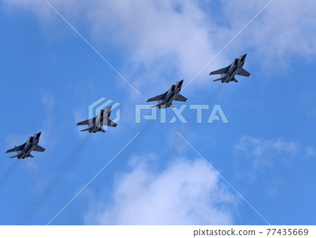MOSCOW, RUSSIA - MAY 7, 2021: Avia parade in Moscow. group jet fighter aircraft Mikoyan MiG-31 in the sky on parade of Victory in World War II in Moscow, Russia MOSCOW, RUSSIA - MAY 7, 2021: Avia parade in Moscow. group jet fighter aircraft Mikoyan MiG-31 in the sky on parade of Victory in World War II in Moscow, Russia 77435669