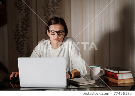 female student freelancer working at home on a task female student freelancer working at home on a task 77436183