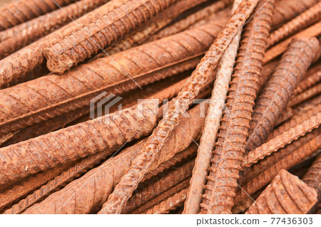 rusty reinforcing bars piled in a heap close-up rusty reinforcing bars piled in a heap close-up 77436303