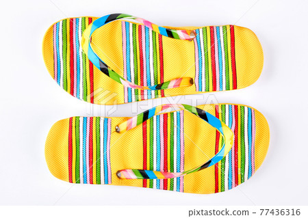 Pair of yellow striped flip flops. Pair of yellow striped flip flops. 77436316