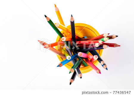 Colored pencils in yellow basket. Colored pencils in yellow basket. 77436547