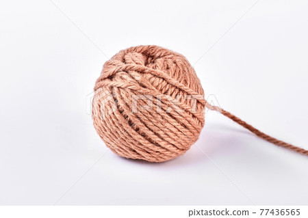 Ball of brown yarn, white background. Ball of brown yarn, white background. 77436565