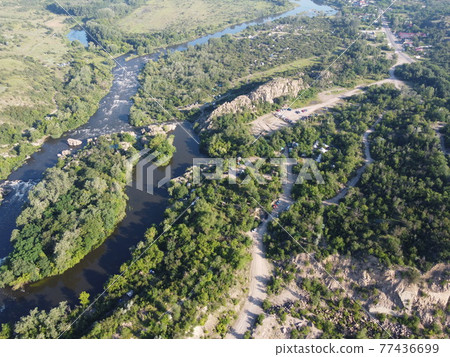Winding bed of the Southern Bug river. River, landscape from a bird's eye view. Rough, rocky terrain. 77436699