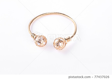 Gold bracelet on a white background. Gold bracelet on a white background. 77437026