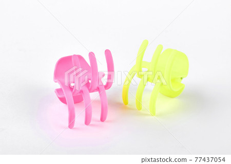 Woman plastic hair clips on white background. Woman plastic hair clips on white background. 77437054