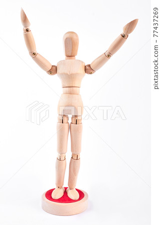 Wooden dummy standing with raised hands. Wooden dummy standing with raised hands. 77437269