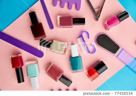 Nail care products, polish on pink background Nail care products, polish on pink background 77438534