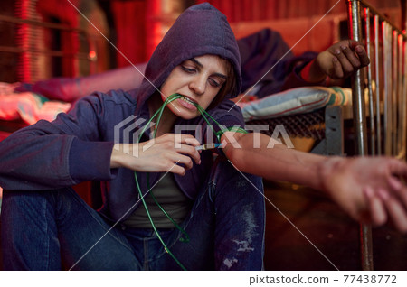 Drug addicts with syringe took a dose in den Drug addicts with syringe took a dose in den 77438772