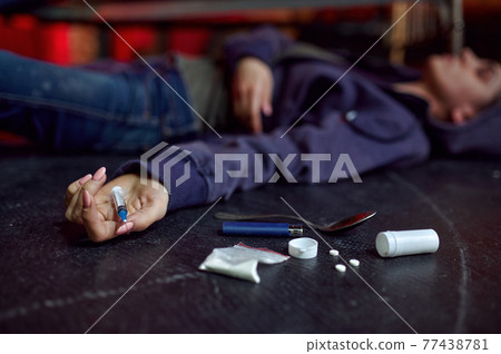 Drug addict man lying on the floor, overdose 77438781