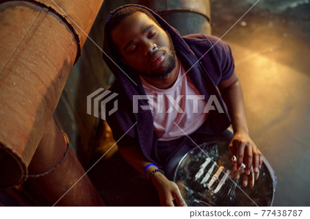 Drug addict man in high after taking a dose 77438787
