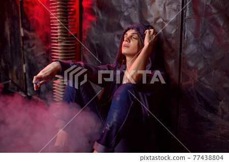 Drug addict woman smokes cigarette while she high 77438804