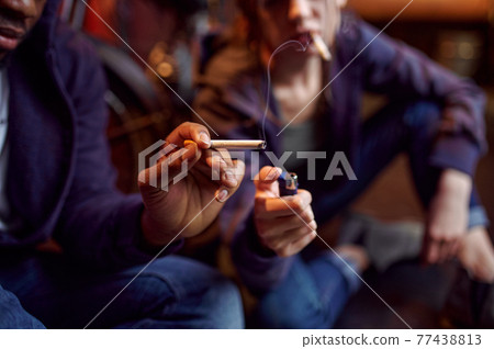 Drug addict man and woman smokes a cigarette Drug addict man and woman smokes a cigarette 77438813