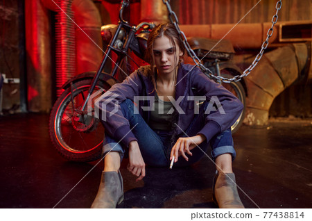 Drug addict woman smokes cigarette while she high Drug addict woman smokes cigarette while she high 77438814