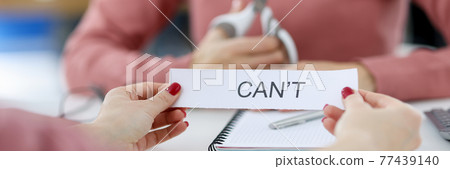 Female hands holding paper with written words can not Female hands holding paper with written words can not 77439140