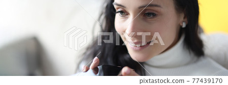 Woman holding mobile phone in hands and dialing voice message 77439170