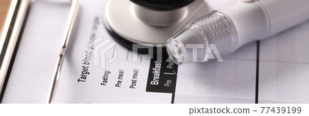 Lancet and blood glucose meter lying on clipboard with medical documents closeup Lancet and blood glucose meter lying on clipboard with medical documents closeup 77439199