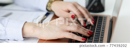 Business woman typing on laptop keyboard in office closeup Business woman typing on laptop keyboard in office closeup 77439202