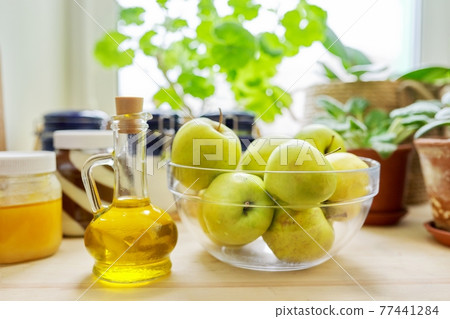 Home pantry, plants in pots, honey, chocolate paste, apples, bottle of olive oil Home pantry, plants in pots, honey, chocolate paste, apples, bottle of olive oil 77441284