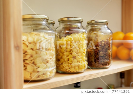 Kitchen pantry, wooden shelves with jars and containers with food, food storage. Kitchen pantry, wooden shelves with jars and containers with food, food storage. 77441291