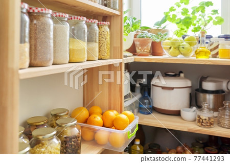 Kitchen pantry, wooden shelves with jars and containers with food, food storage. Kitchen pantry, wooden shelves with jars and containers with food, food storage. 77441293
