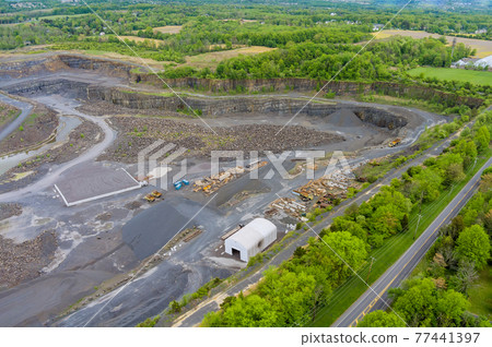 Large, open-pit mine showing the industrial exterior, ore mining quarry Large, open-pit mine showing the industrial exterior, ore mining quarry 77441397
