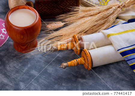 Torah and tallis in the Traditional celebration season Jewish holiday Shavuot on kosher dairy food 77441417