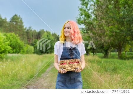 Young teenage girl with basket of fresh plucked strawberries Young teenage girl with basket of fresh plucked strawberries 77441961