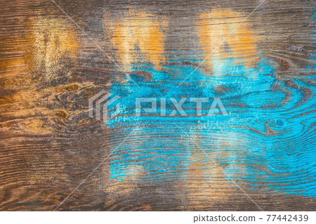 Traces of paint on the old texture of a dark wooden surface with an abstract pattern, background Traces of paint on the old texture of a dark wooden surface with an abstract pattern, background 77442439