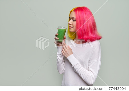 Young teenager girl with green vegetable smoothie drink, healthy vegan diet, copy space 77442904