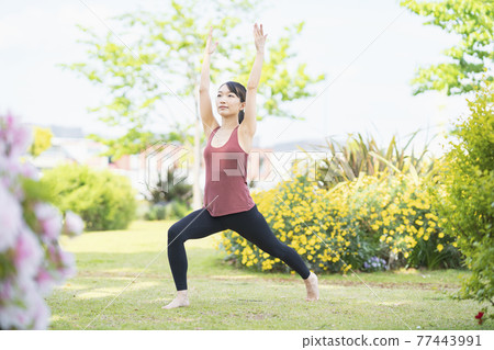 Young woman doing yoga in a green park Young woman doing yoga in a green park 77443991
