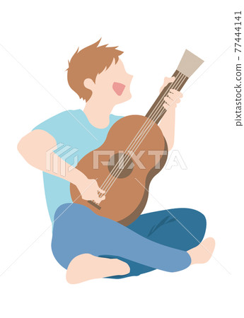 A man sitting on the floor and playing the guitar 77444141