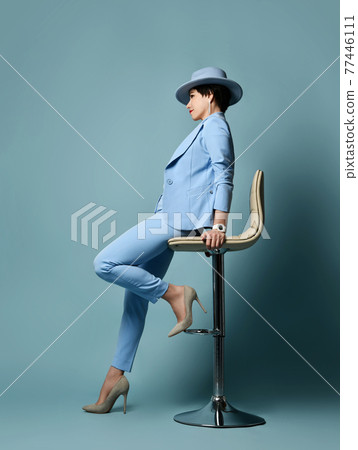 Short haired brunette woman in blue business suit Short haired brunette woman in blue business suit 77446111