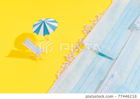 Summer vacation concept during pandemic. Social distance of people on beach. On yellow background, there are seashells and standing chazlongue and an umbrella from sun. Medical masks are depicted as Summer vacation concept during pandemic. Social distance of people on beach. On yellow background, there are seashells and standing chazlongue and an umbrella from sun. Medical masks are depicted as 77446218