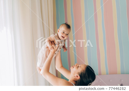 Young mother hugs her mixed race child. Child adoption and In Vitro Fertilization IVF  77446282