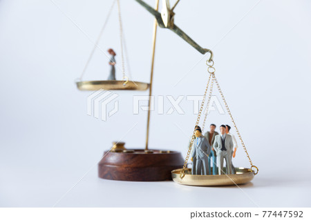 Image of gender balance between men and women on the balance 77447592