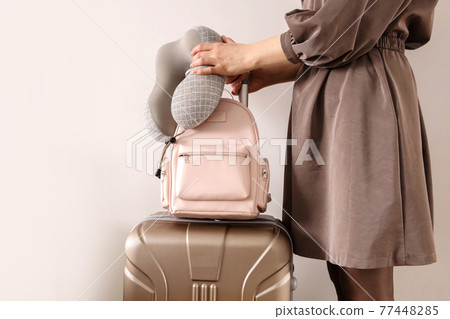 Closeup hands of travel woman holding backpack and stylish suitcase ready to business trip vacation 77448285