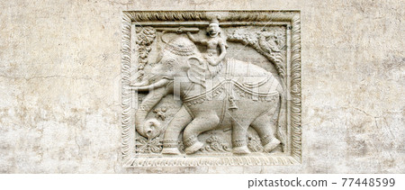 Grunge background with stone texture and bas-relief with elephant rider Grunge background with stone texture and bas-relief with elephant rider 77448599