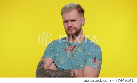 Dissatisfied trendy man asking reason of failure, expressing disbelief irritation, feeling bored Dissatisfied trendy man asking reason of failure, expressing disbelief irritation, feeling bored 77449141