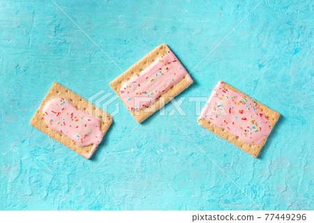 Pop tarts, overhead flat lay shot on a blue background Pop tarts, overhead flat lay shot on a blue background 77449296