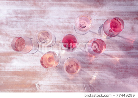 Rose wine types, shot from above, toned in pink, many glasses of wine Rose wine types, shot from above, toned in pink, many glasses of wine 77449299