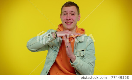 Tired serious teen man showing time out gesture, limit or stop sign, no pressure, i need more time Tired serious teen man showing time out gesture, limit or stop sign, no pressure, i need more time 77449368