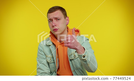 Teenager man raises thumbs up agrees or gives positive reply recommends advertisement likes good 77449524