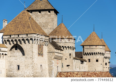 panoramic view of historic Chateau de Chillon at Lake Geneva in summer, Canton of Vaud, Switzerland 77449812