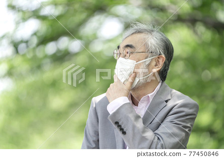 Senior man getting lost wearing a mask 77450846