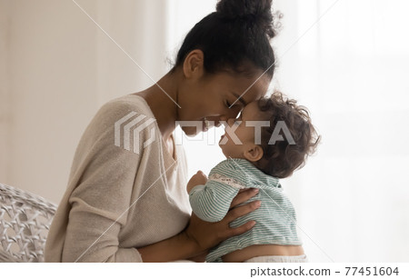 Happy African American mom hug newborn baby Happy African American mom hug newborn baby 77451604