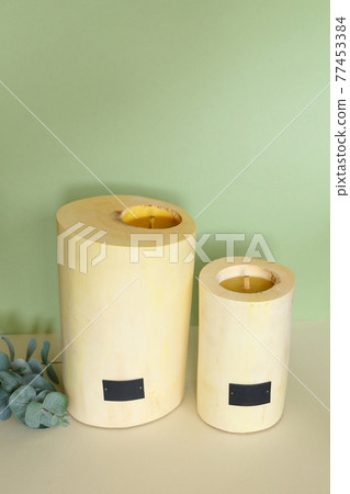 Wooden candle holder rustic interior centerpiece with candles in a cozy barn setting. 77453384