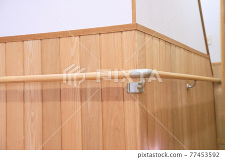 Wooden railings on the wainscot at the corners of the indoor corridor 77453592